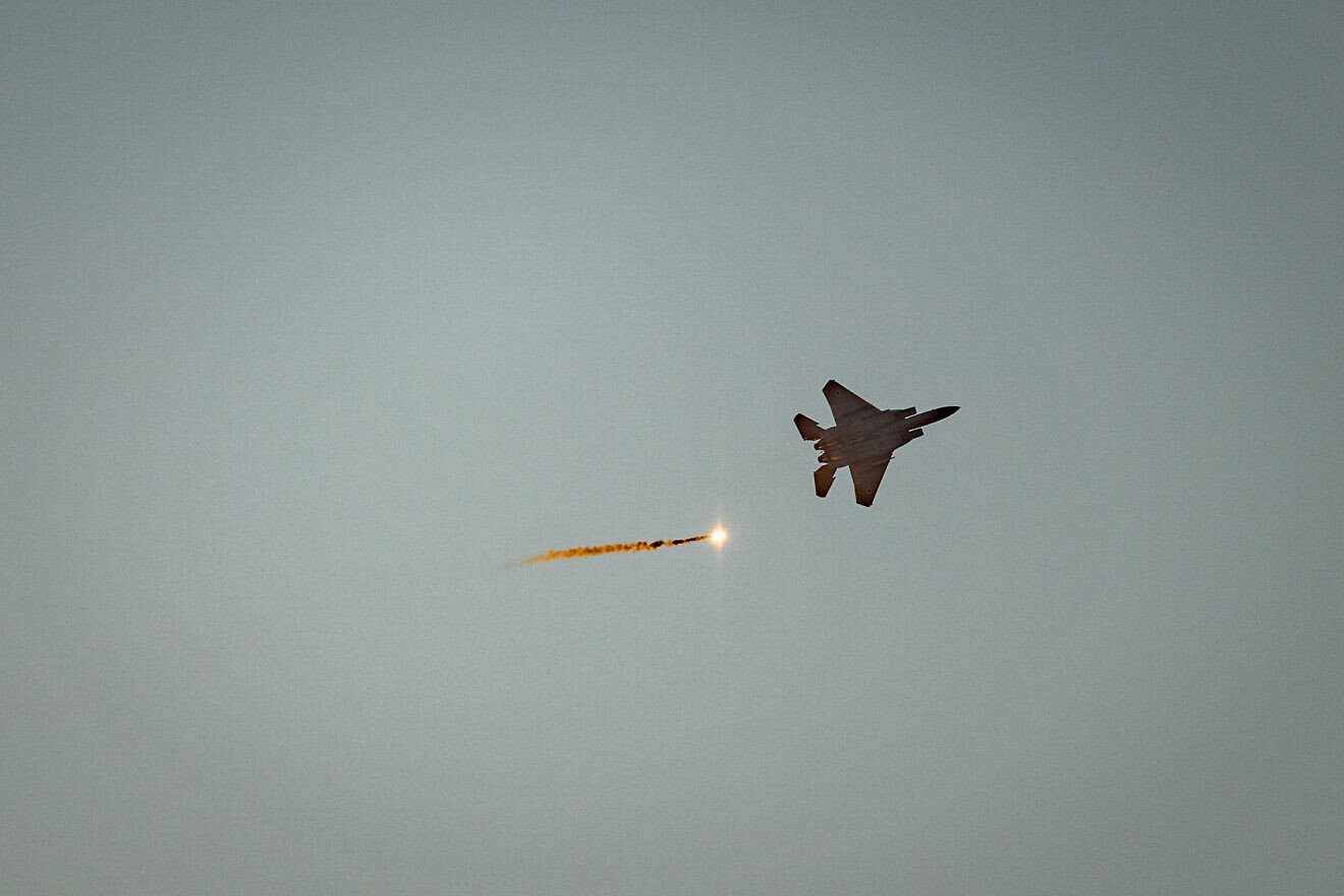 An Israeli Air Force fighter jet fires flares as it flies over the Gaza Strip, as seen from the Israeli side of the border, July 20, 2025. Photo by Chaim Goldberg/Flash90.