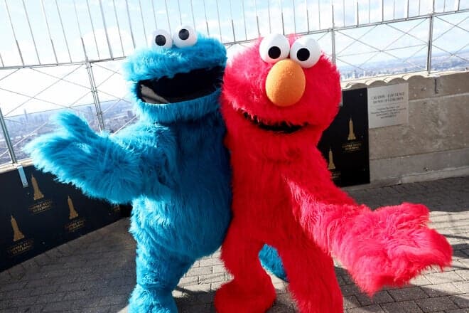Cookie Monster and Elmo celebrate the return of Sesame Street Live! at the Empire State Building in New York City, Feb. 18, 2022. Photo by Dimitrios Kambouris/Getty Images for Empire State Realty Trust.
