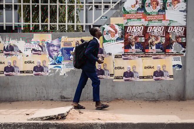 A young student walks pasts various campaign posters at Lagos-Island on Feb. 23, 2023 in Lagos, Nigeria. Photo by Benson Ibeabuchi/Getty Images.