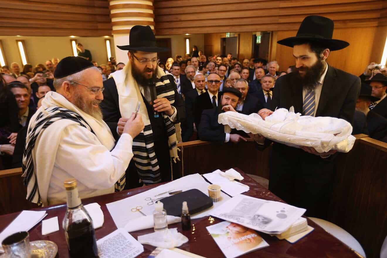 Orthodox Jews pass around a newborn before his circumcision at the Chabad Lubawitsch Orthodox Jewish synagogue in Berlin, Germany, March 3, 2013. Photo by Sean Gallup/Getty Images.