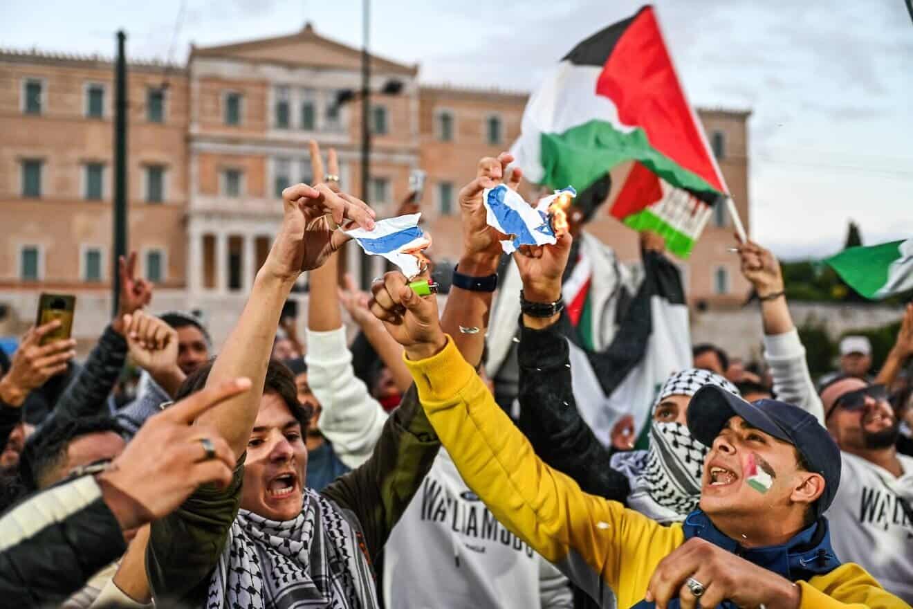 Protesters burn a paper painted as the Israeli flag during a rally in support of Palestinians in Athens, on Oct. 18, 2023. Photo by Theophile Bloudanis/AFP via Getty Images.