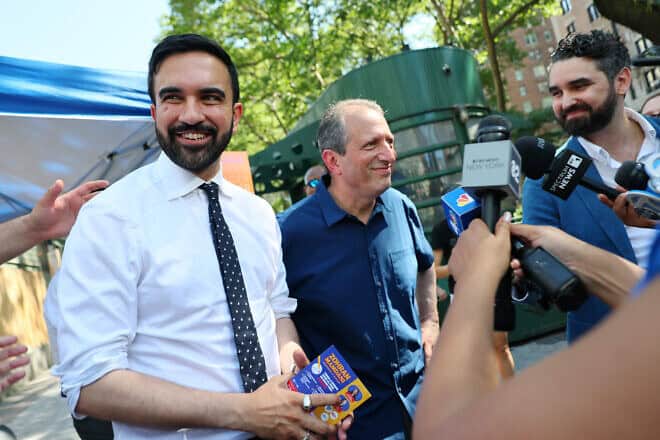 New York mayoral candidate Zohran Mamdani, a Democratic state assemblyman, and New York City Comptroller Brad Lander speak with members of the press as they greet voters on Broadway, on June 24, 2025. Photo by Michael M. Santiago/Getty Images.
