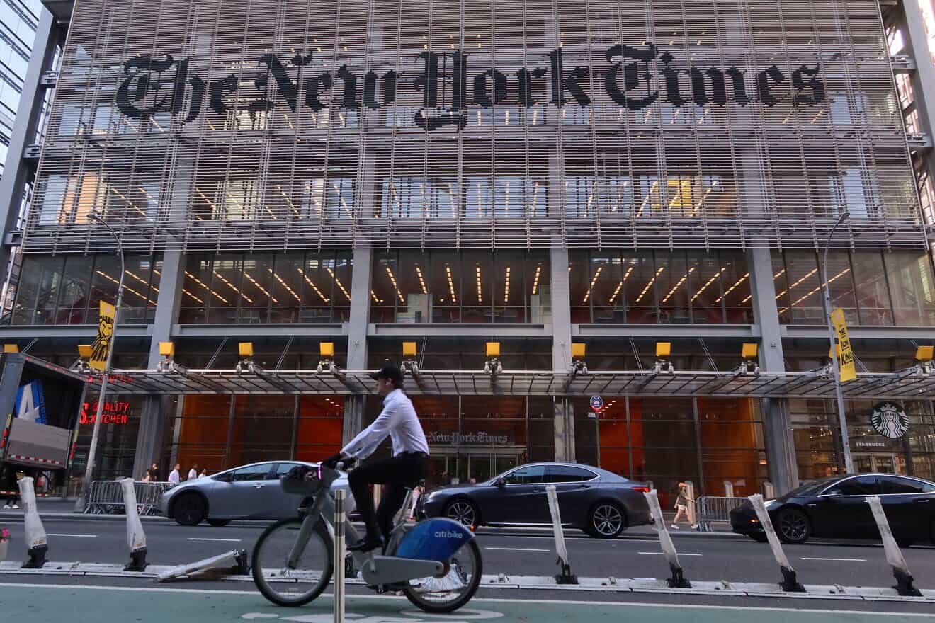 A person cycles past the front of “The New York Times” headquarters on Eighth Avenue in Midtown Manhattan on June 24, 2025. Photo by Gary Hershorn/Getty Images.