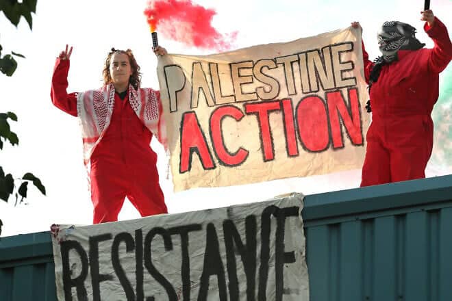Activists hold a "Palestine Action" banner while on the roof of Guardtech, a company they accuse of being in business with Israeli defense contractor Elbit Systems, in Brandon, United Kingdom, on July 1, 2025. Photo by Martin Pope/Getty Images.