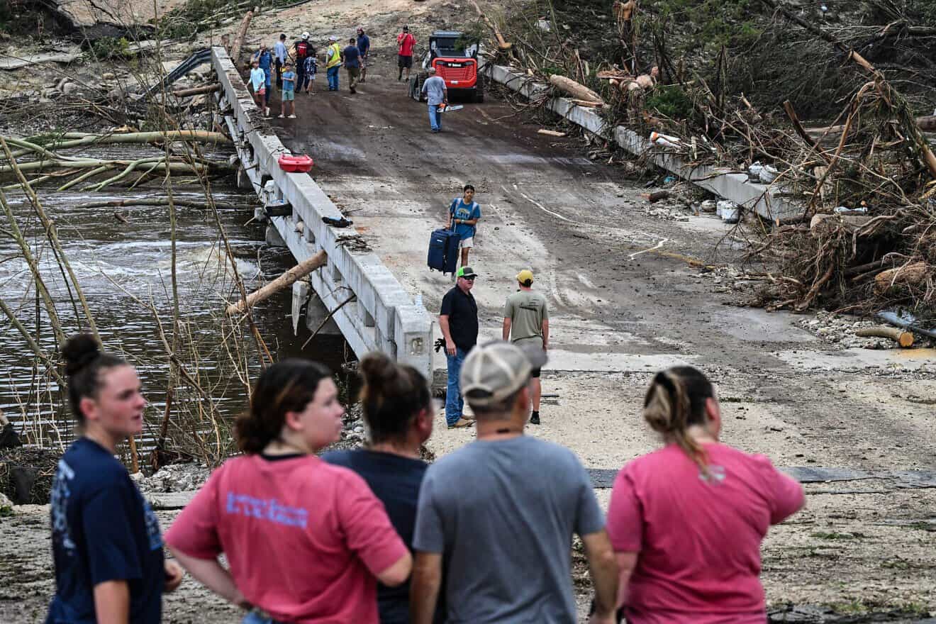 Law enforcement and volunteers continue to search for missing people near Camp Mystic, the site where at least 20 girls went missing after flash flooding in central Texas, July 5, 2025. Photo by Ronaldo Schemidt/AFP via Getty Images.