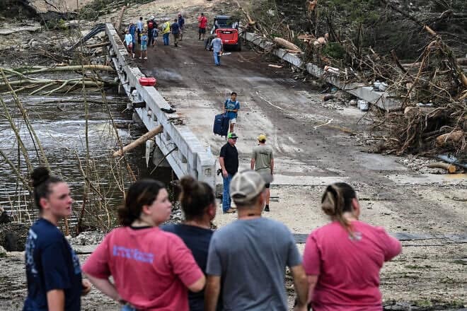 Law enforcement and volunteers continue to search for missing people near Camp Mystic, the site where at least 20 girls went missing after flash flooding in central Texas, July 5, 2025. Photo by Ronaldo Schemidt/AFP via Getty Images.