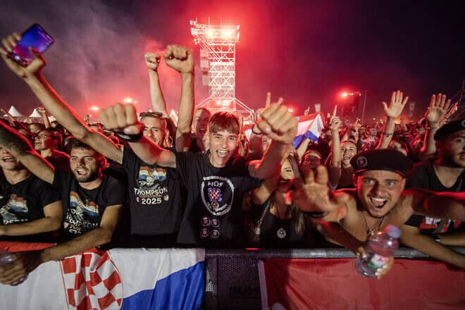 Fans of Croatian nationalist singer Marko Perkovic Thompson gather at the Zagreb Hippodrome during a concert by the singer, who is known for his sympathies for the country's World War II Nazi-allied regime, on July 5, 2025. Photo by Damir Sencar/AFP via Getty Images.