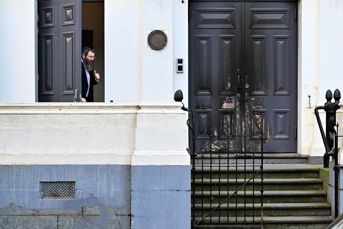 Rabbi Dovid Gutnick speaks to the media next to the burnt front-door entrance of the East Melbourne Synagogue in Melbourne on July 6, 2025. Photo by William West/AFP via Getty Images.