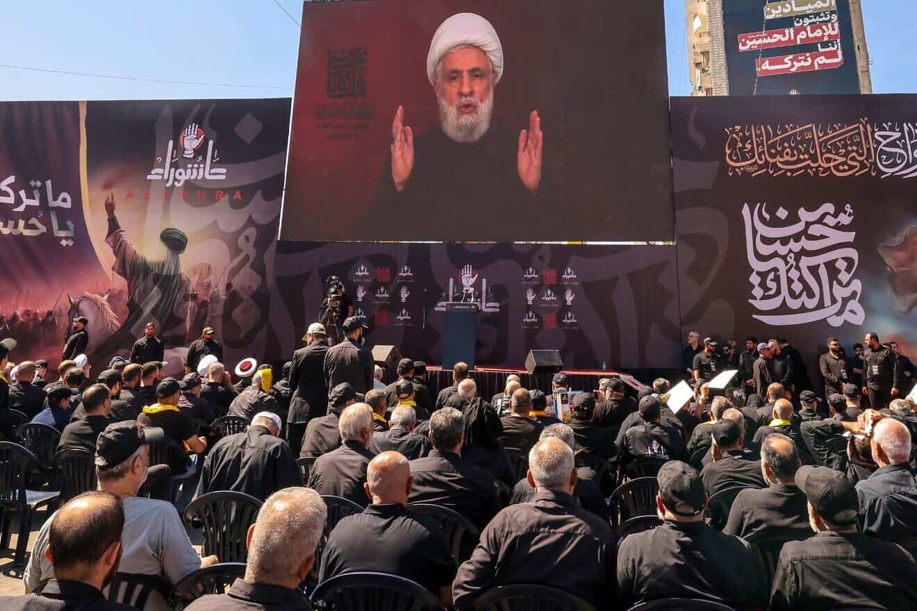 Lebanese terrorist supporters listen to a televised speech by Hezbollah chief Naim Qassem, July 6, 2025. Photo by Anwar Amro/AFP.