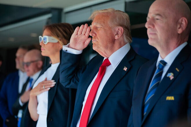 U.S. President Donald Trump (C) and first lady Melania Trump and FIFA President Gianni Infantino greet the crowd before watching the final match of the FIFA Club World Cup at MetLife Stadium on July 13, 2025 in East Rutherford, New Jersey. Photo by Chip Somodevilla/Getty Images.