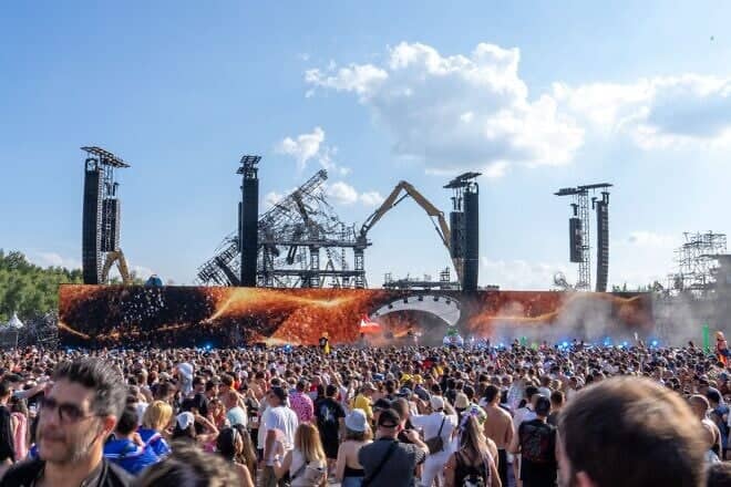 People attend the first day of the Tomorrowland electronic music festival, Friday 18 July 2025, in Boom, Belgium. Photo by Marius Burgelman/Belga Mag/AFP via Getty Images.