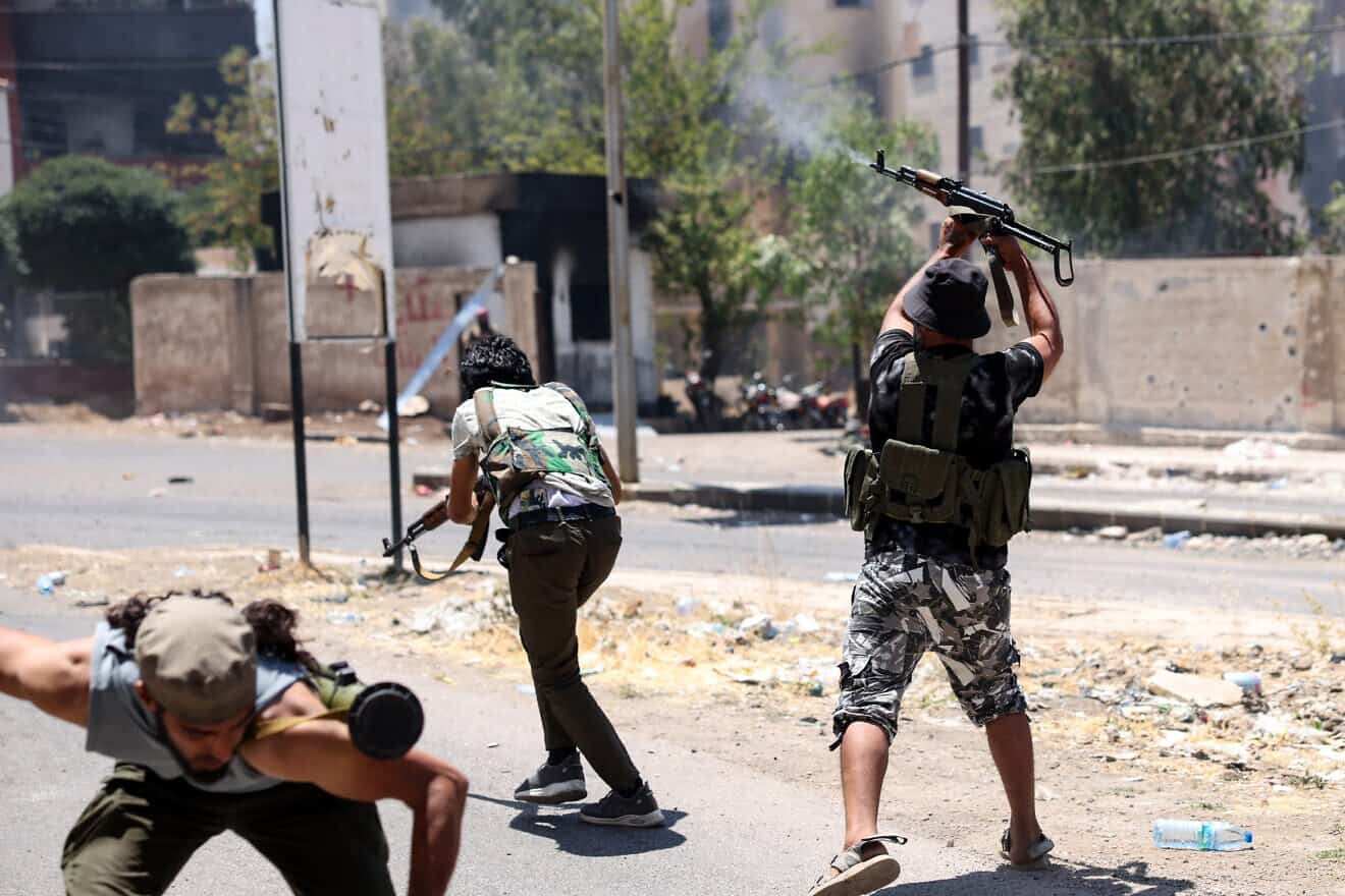Bedouin tribal gunmen engage in combat with Druze fighters in Sweida city, in Syria's southern Sweida Province, on July 19, 2025. Photo by Bakr Alkasem/AFP via Getty Images.