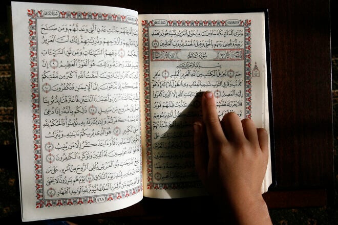 A Palestinian boy read the Koran at a mosque in their summer camp for the study of Islam's holy book organized by Hamas in Rafah in the southern Gaza Strip on June 5, 2014. Photo by NurPhoto/Corbis via Getty Images.