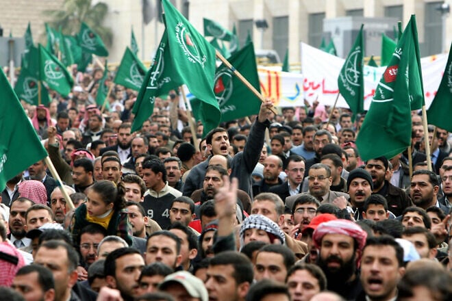 Jordanians and Palestinians chant slogans and wave Muslim Brotherhood flags during a demonstration in the Jordanian capital Amman against Israel's deadly assault on the Gaza Strip March 2, 2008. Photo by Awad Awad/AFP via Getty Images.