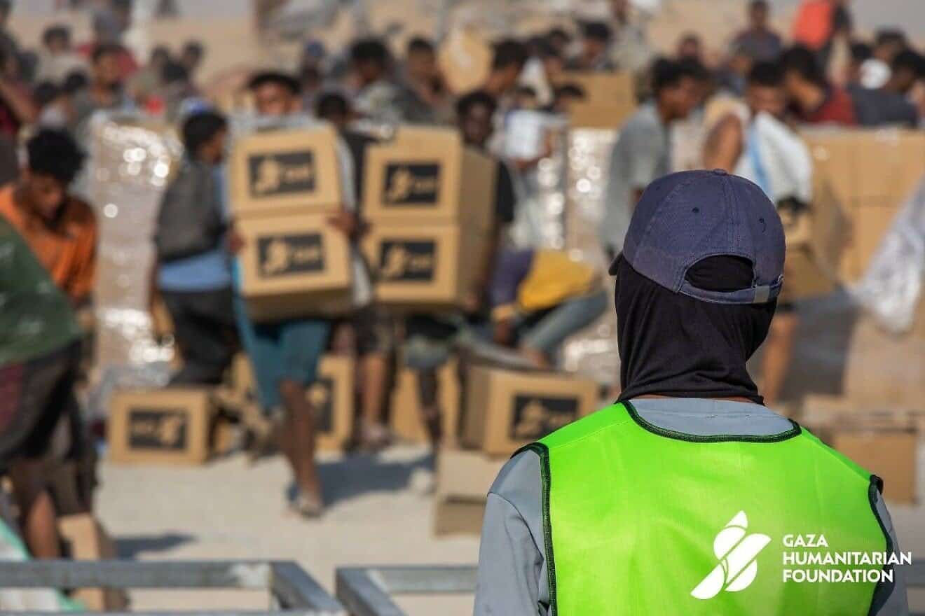 Gazans pick up food packages at a Gaza Humanitarian Foundation aid distribution site. Source: @GHFUpdates/X.