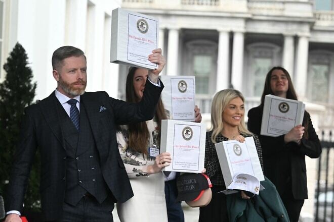 From left: Political commentator Rogan O'Handley, aka DC Draino, TikToker Chaya Raichik, commentator Liz Wheeler and U.S. conservative activist Scott Presler carry binders bearing the seal of the U.S. Justice Department reading "The Epstein Files: Phase 1" as they walk out of the West Wing of the White House in Washington, D.C., on Feb. 27, 2025. The Trump administration has said it would release documents on late tycoon and convicted sex trafficker Jeffrey Epstein, who was found dead in his prison cell in 2019. Photo by Jim Watson/AFP via Getty Images.