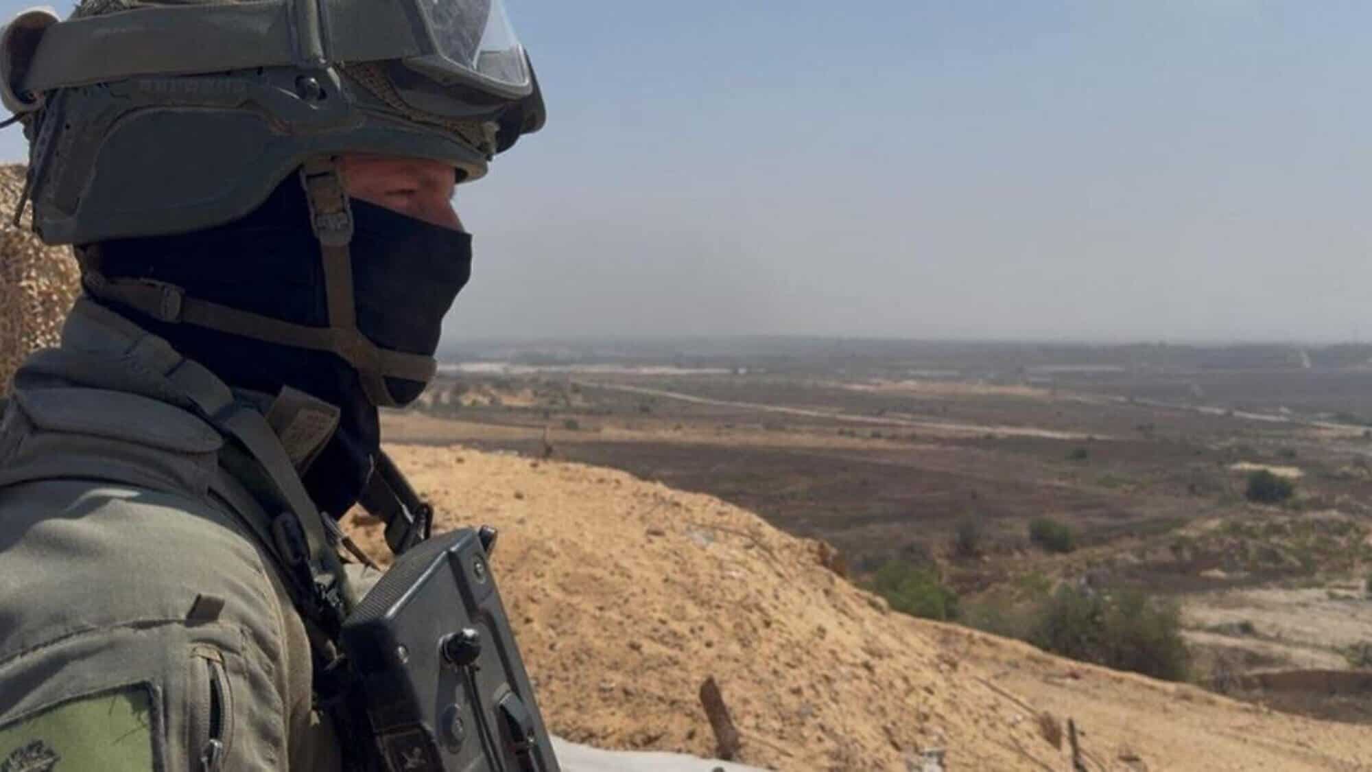 Lt. Col. T., commander of the IDF's 969th Battalion, stands in the northern Gaza Strip and looks down on Beit Hanoun and Kibbutz Kibbutz Kfar Aza, July 17, 2025. Credit: ILTV.