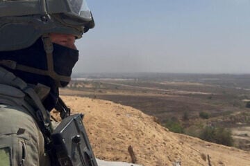 Lt. Col. T., commander of the IDF's 969th Battalion, stands in the northern Gaza Strip and looks down on Beit Hanoun and Kibbutz Kibbutz Kfar Aza, July 17, 2025. Credit: ILTV.