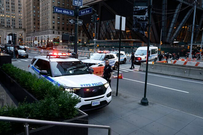 Police cars drive on the sidewalk as police respond to a shooting incident in the Midtown Manhattan neighborhood of New York on July 28, 2025. Credit: John Lamparski/AFP via Getty Images.