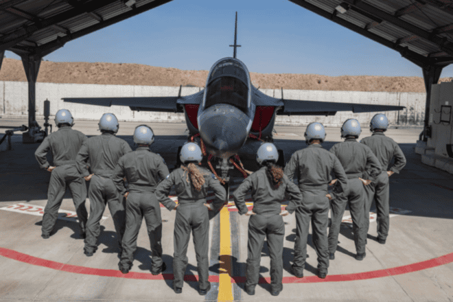 Graduates of the IAF's Flight Course 190 surround an aircraft in its hangar. Credit: Israel Defense Forces.