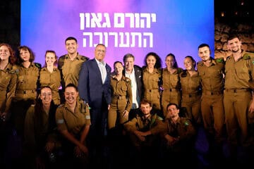 Yehoram Gaon and Jerusalem Mayor Moshe Leon pose with IDF soldiers at the exhibition, July 10, 2025. Photo by Ricky Rachman.