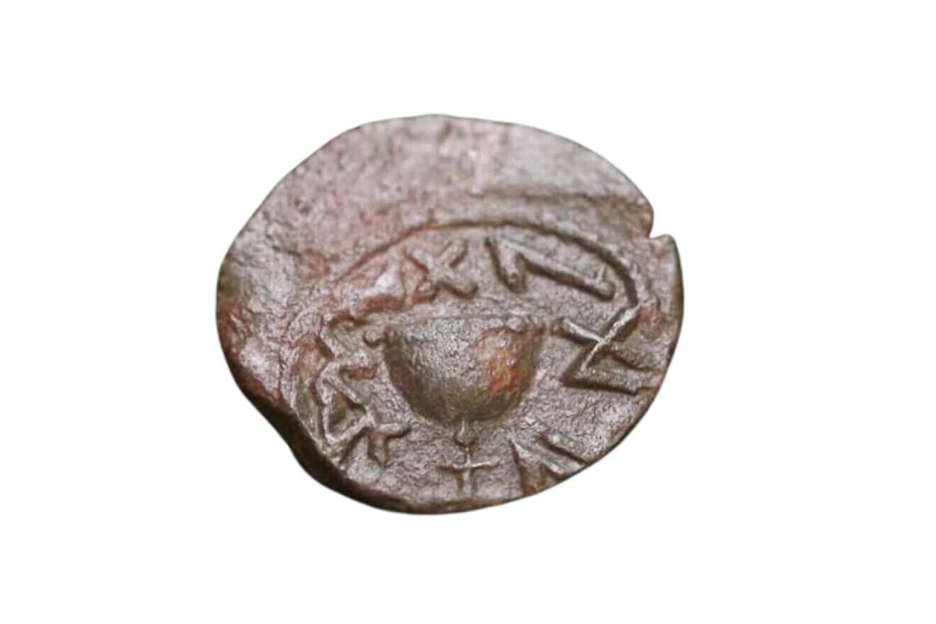 This bronze coin dating back two millennia to the Jewish Revolt against the Romans uncovered near the Temple Mount in Jerusalem features a chalice with an inscription in ancient Hebrew "For the  Redemption of Zion." Credit: Emil Aladjem/IAA.
