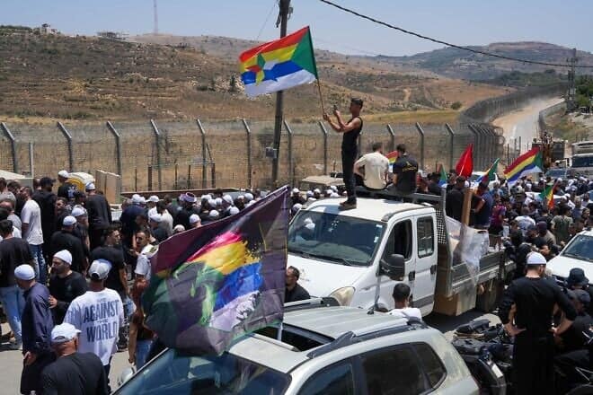Druze residents protest near the Israeli-Syrian border fence in solidarity with their community in Syria, in Majdal Shams, July 16, 2025. Photo by Ayal Margolin/Flash90.