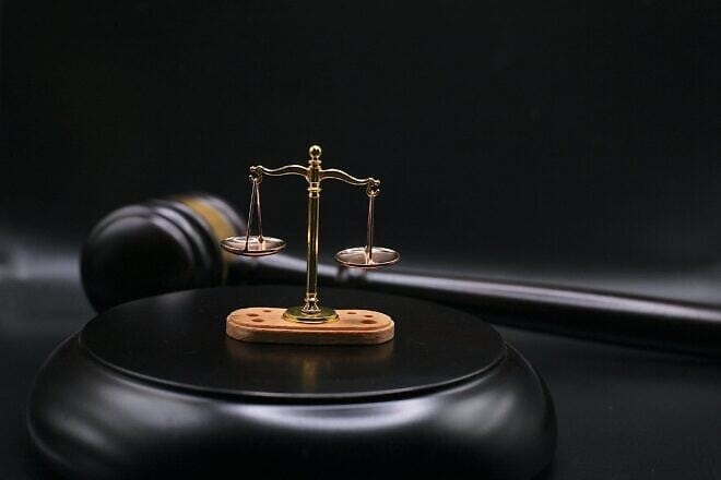 The scales of justice on top of a gavel's block. Credit: Sergei Tokmakov/Pixabay.