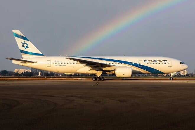 An El Al plane on the runway of Ben-Gurion International Airport with a rainbow in the background. Credit: Courtesy.