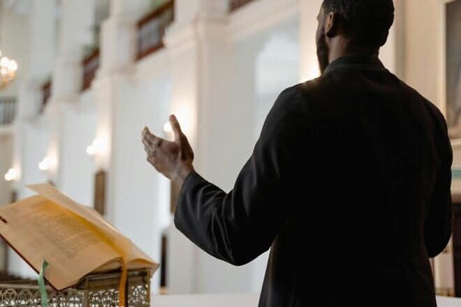 A clergy member speaking in a place of worship. Credit: Mart Production/Pexels.