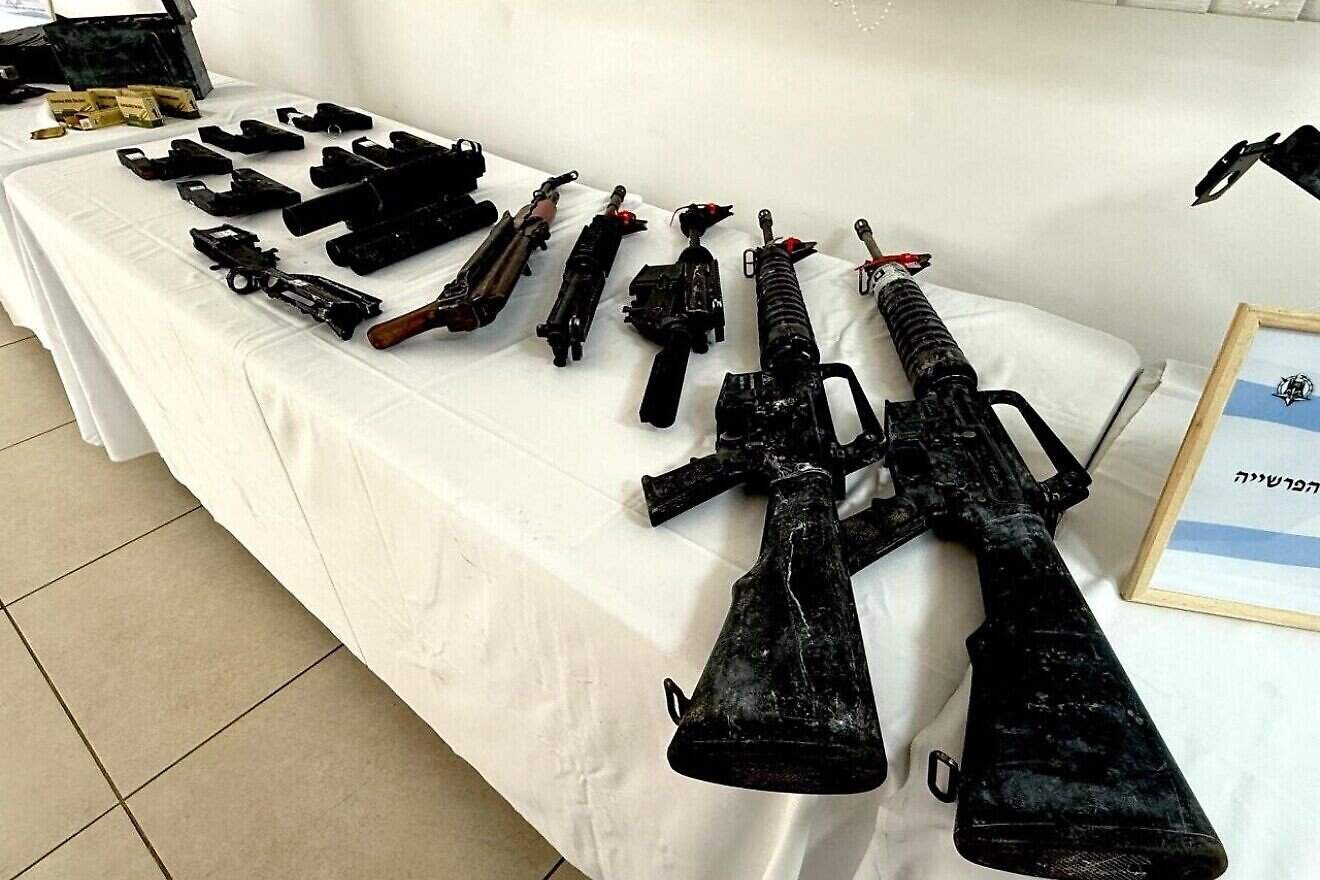 Weapons seized in the Yarka raid, including pistols, rifles, explosives and ammunition. Credit: Israel Police.