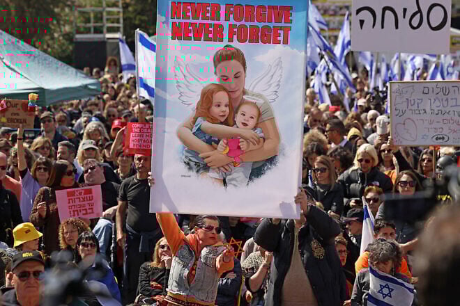 People pay their respects to Shiri Bibas and her sons at "Hostage Square" in Tel Aviv on the day of their funeral procession, Feb. 26, 2025. Photo by Ahmad Gharabli/AFP via Getty Images.