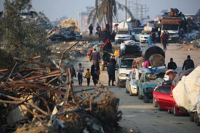 Displaced Palestinians move with their belongings on Salah al-Din road as people make their way from the south to the northern parts of the Gaza Strip, in Nuseirat in central Gaza, on Jan. 29, 2025. Photo by Eyad Baba/AFP via Getty Images.