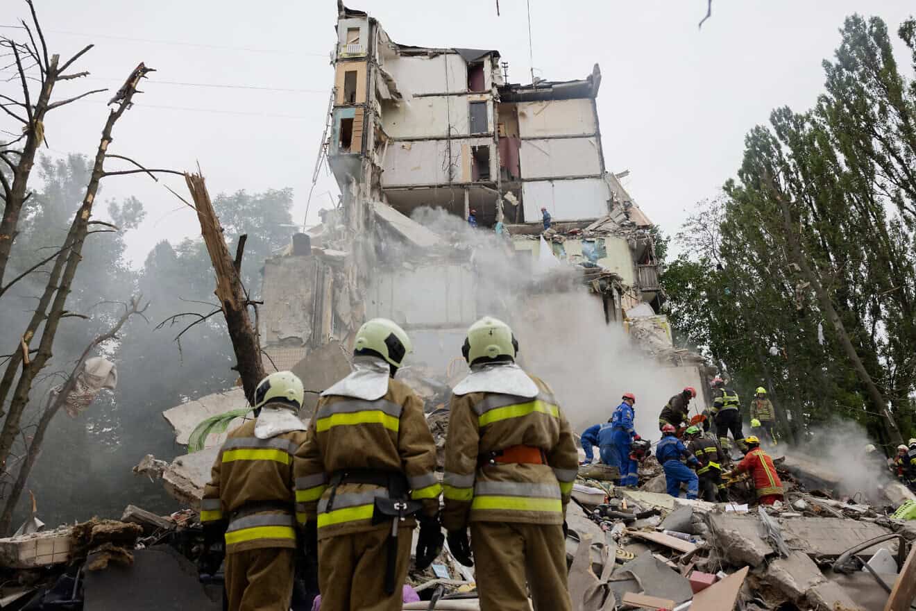Rescuers clear debris at the site of a destroyed residential building following a Russian air attack in Kyiv on July 31, 2025. Photo by Tetiana Dzhafarova/AFP via Getty Images.