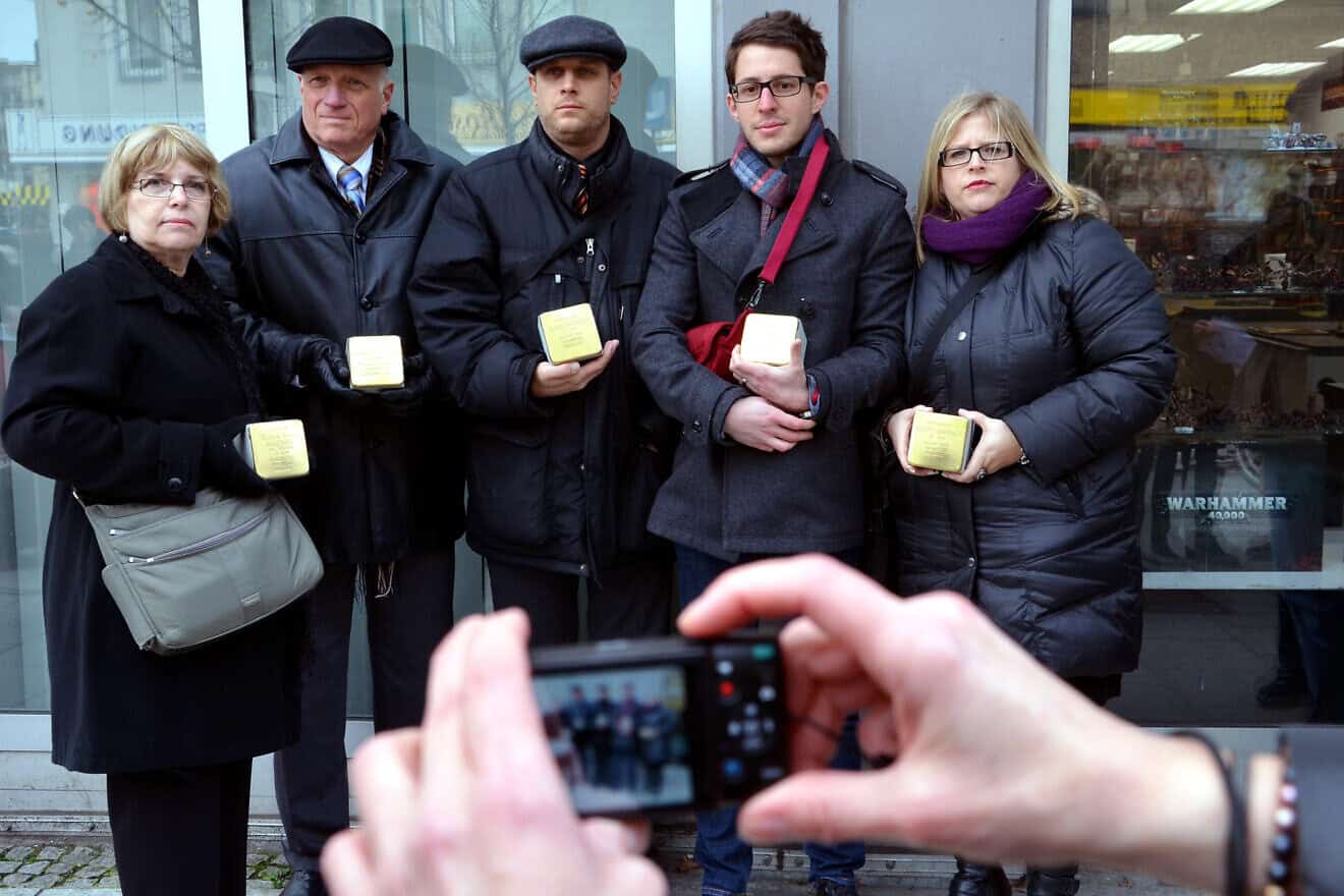 The Maissner family involved with the Stolpersteine project, concrete cubes bearing brass plates inscribed with the name and life dates of victims of German Nazi extermination or persecution: (From left) Hope Maissner, Cantor Benjamin (“Beny”) Maissner, Tal Maissner, Dean Solomon of England and Shira Maissner, Nov. 12, 2013. Credit: Bernd Schwabe in Hanover, Germany, via Wikimedia Commons.