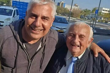 Volunteer Amir Golub with Holocaust survivor Ezriel Tziperbert. Credit: Courtesy.