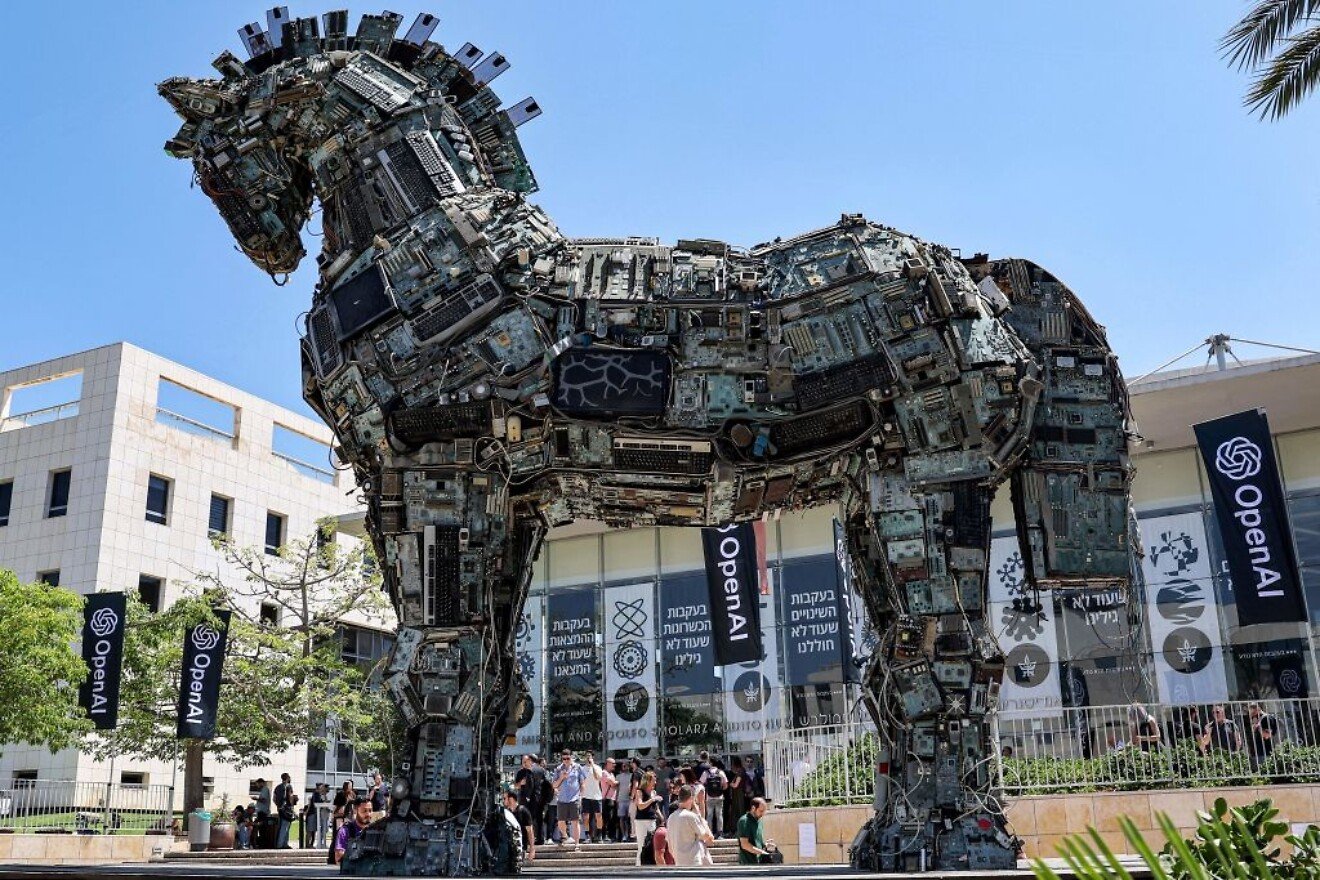 Banners of U.S. artificial intelligence company OpenAI fly near an installation depicting a Trojan horse built entirely out of microelectronic circuit boards and other computer components, outside the campus of Tel Aviv University on June 5, 2023. Photo by Jack Guez/AFP via Getty Images. Banners of U.S. artificial intelligence company OpenAI fly near an installation depicting a Trojan horse built entirely out of microelectronic circuit boards and other computer components, outside the campus of Tel Aviv University on June 5, 2023. Photo by Jack Guez/AFP via Getty Images.