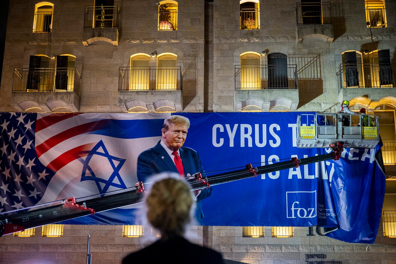 Workers hang a large banner featuring a picture of U.S. President Donald Trump in Jerusalem, Oct. 12, 2025. Photo by Yonatan Sindel/Flash90.