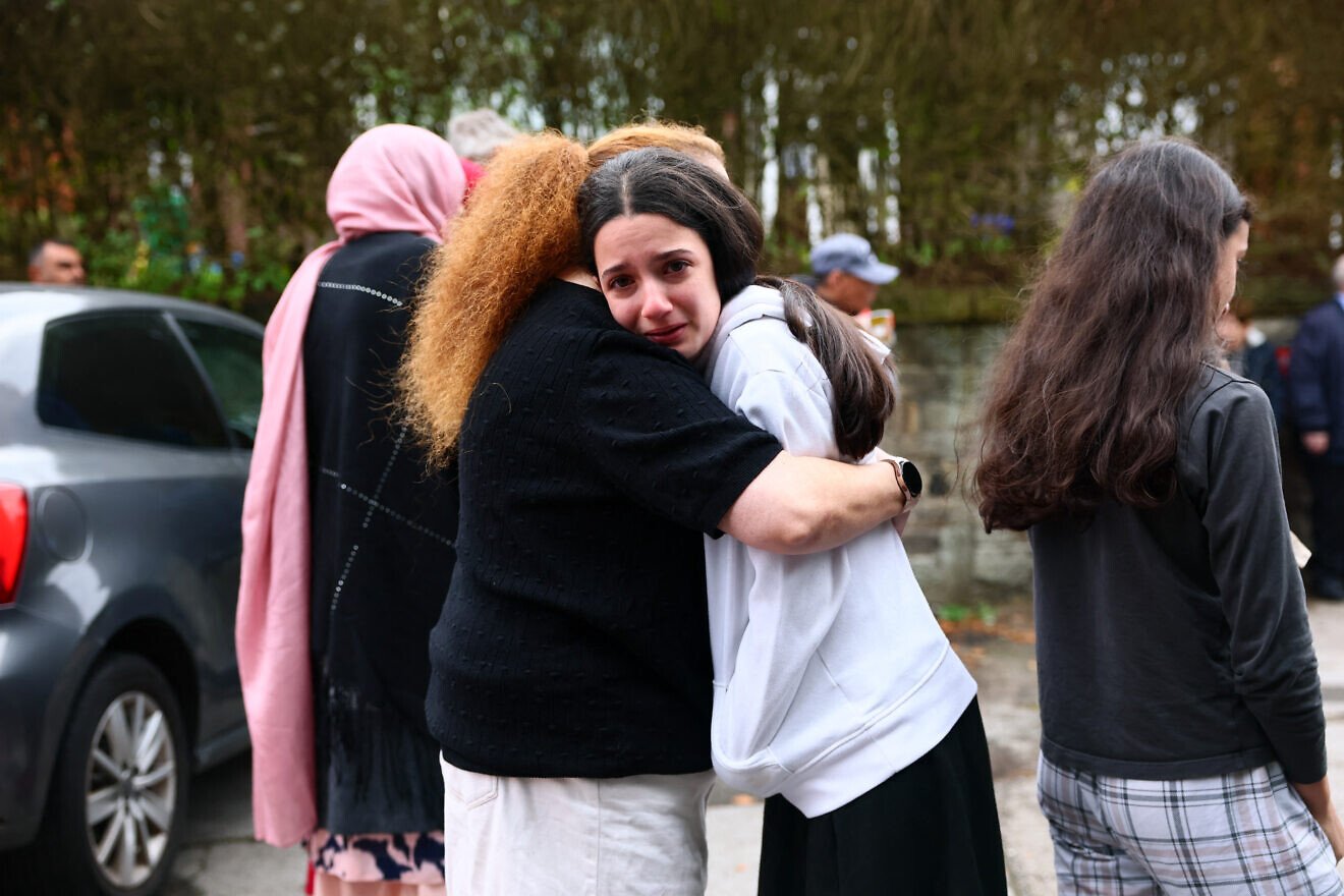 Members of the community comfort each other near Heaton Park Hebrew Congregation in Manchester, England, following domestic terror attack at the synagogue that resulted in the deaths of two people Yom Kippur, Oct. 2, 2025, Photo by Paul Currie/AFP via Getty Images.