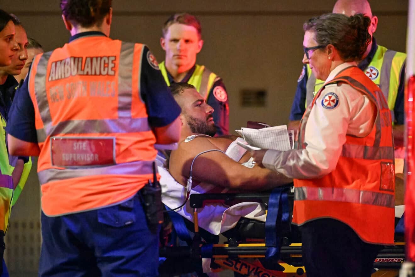 Health workers move a man on a stretcher to an ambulance after a shooting attack at Bondi Beach in Sydney on Dec. 14, 2025. Photo by Saeed Khan/AFP via Getty Images.