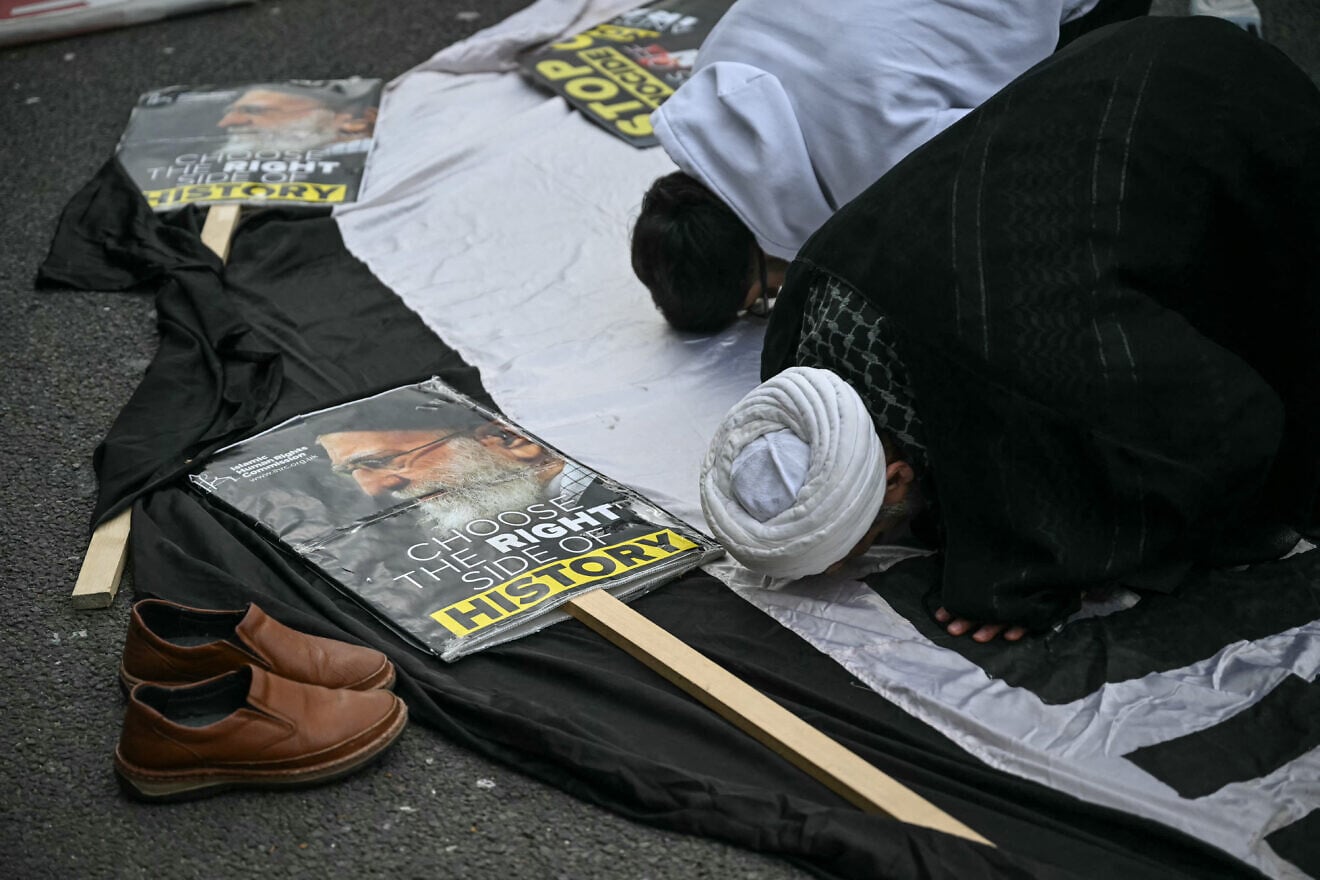 Pro-Iran regime supporters pray on the sidelines of an annual protest, this year a static protest, held by pro-Palestinian group Al-Quds in central London on March 15, 2026. The U.K. government banned an annual pro-Palestinian march organized by a group "supportive of the Iranian regime." A static protest and counter-protest went ahead in place of the march. Photo by JUSTIN TALLIS/AFP via Getty Images.